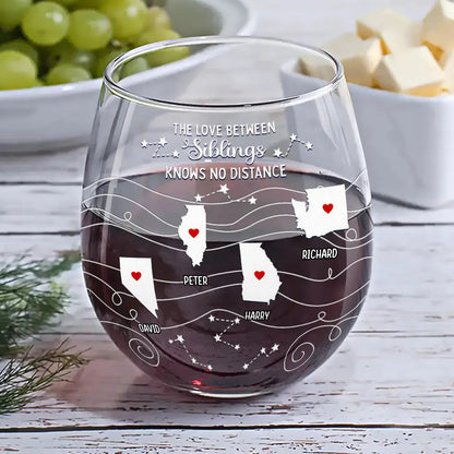 Personalized stemless wine glass with state map design, filled with red wine, ideal for family gatherings.