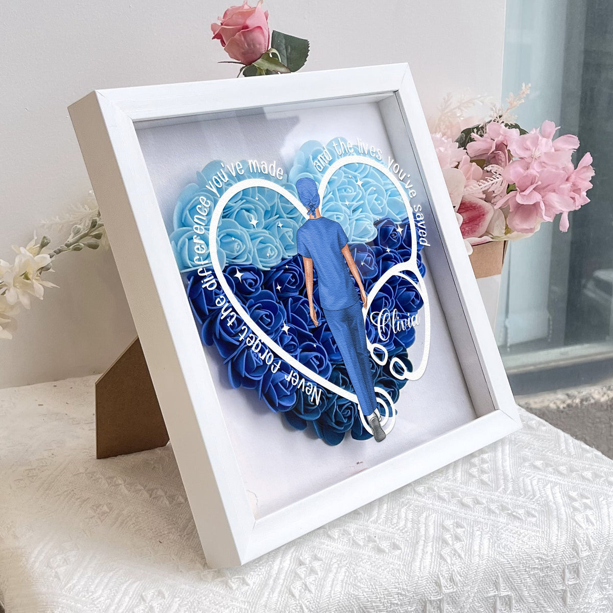 Heart-shaped flower shadow box gift for nurses, blue & white PE foam flowers in white frame.